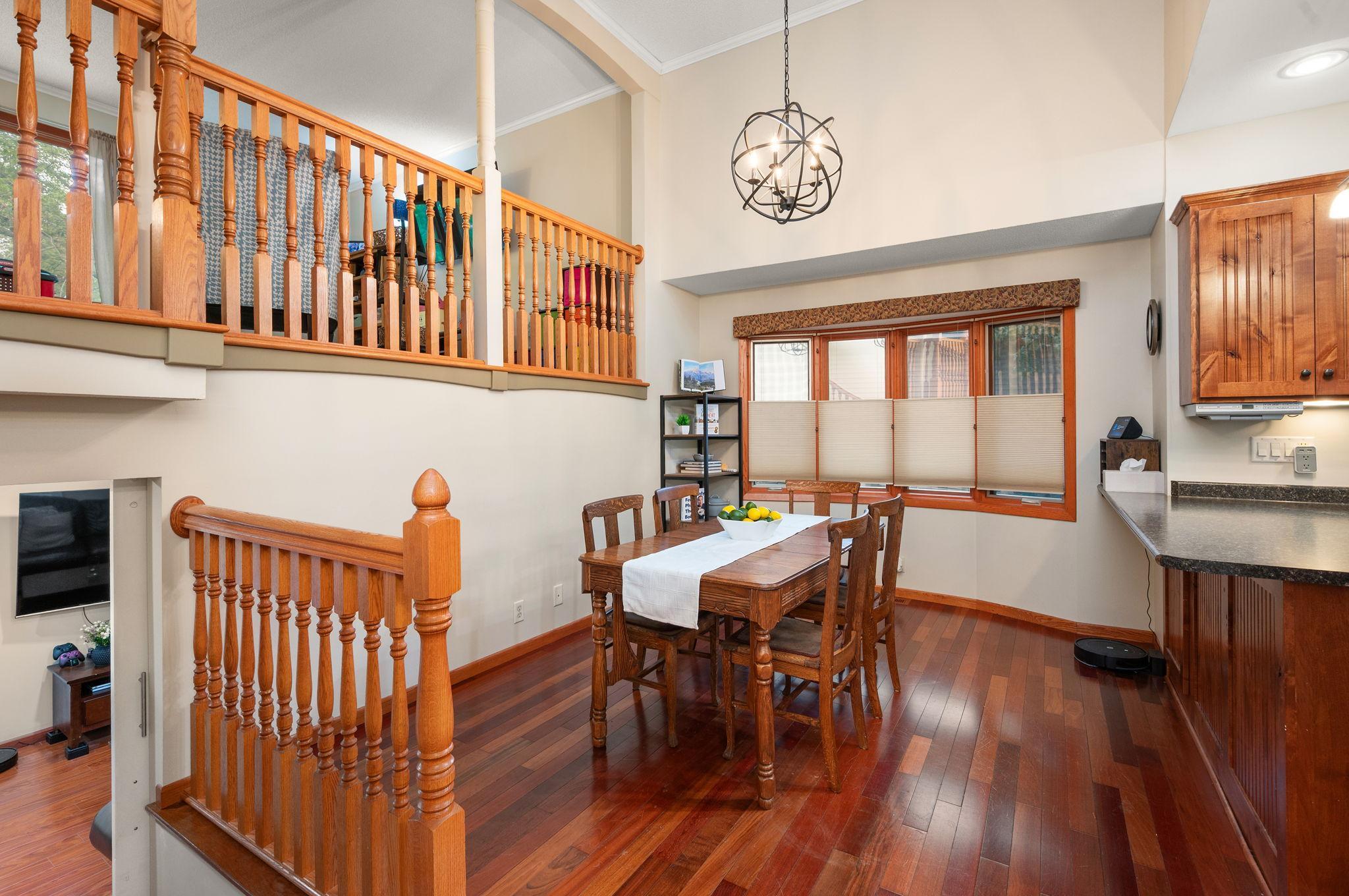 Bright dining space adjacent to the foyer, featuring warm wood accents and an open architectural feel