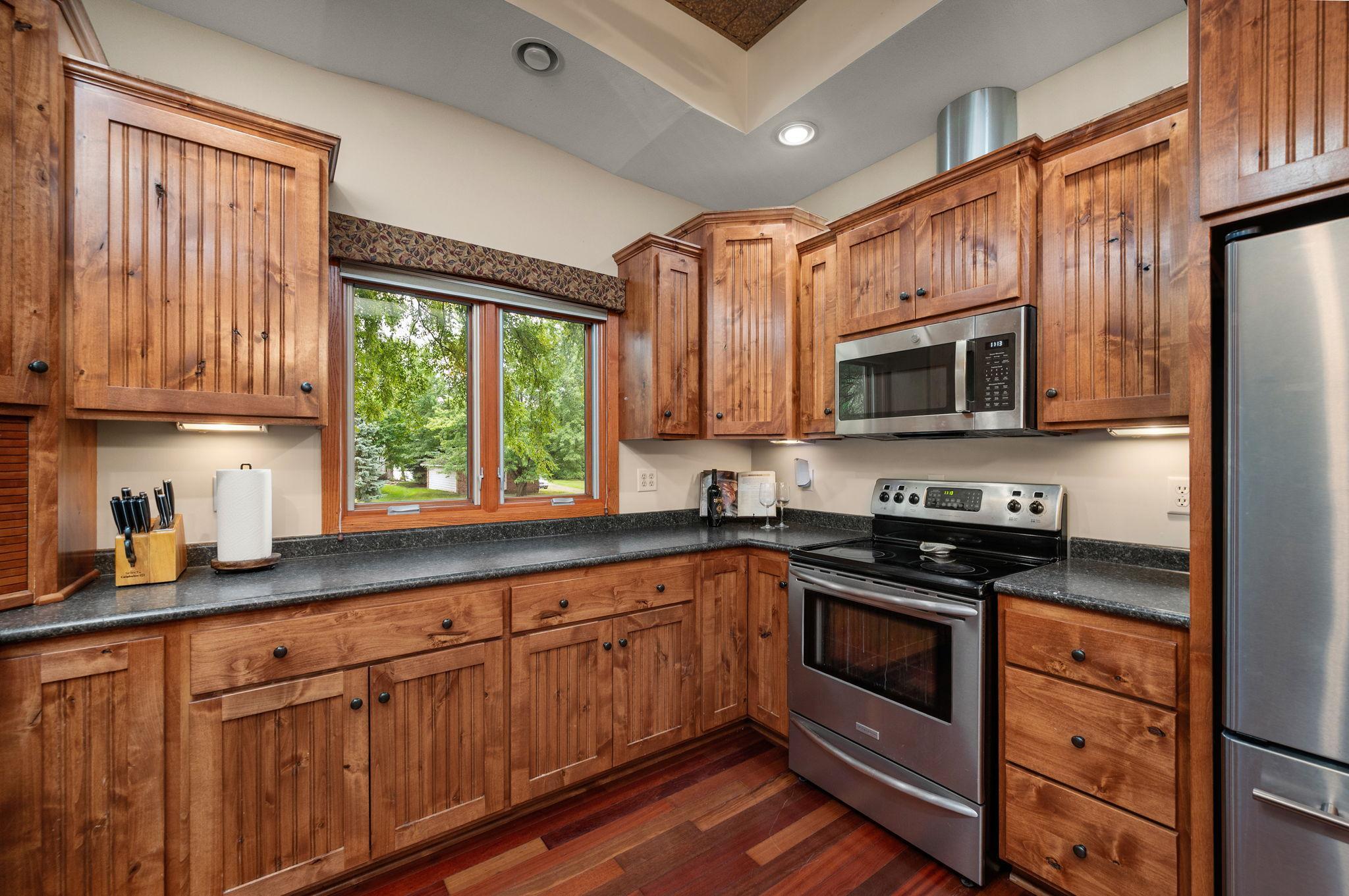 Well-appointed kitchen complete with built-in microwave, ample storage cabinets, and bright natural light from the beautiful windows