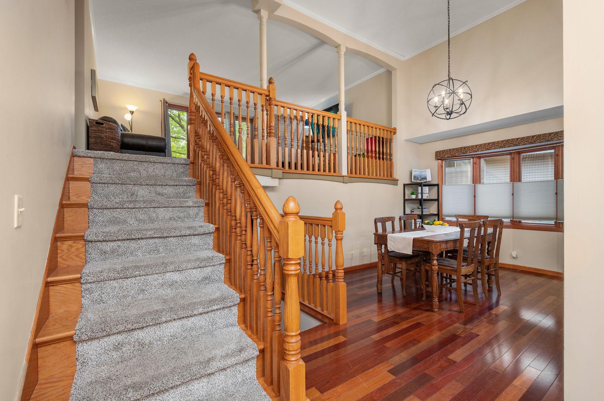 Soaring entry hall featuring hardwood floors, and seamless access to the upper and lower levels