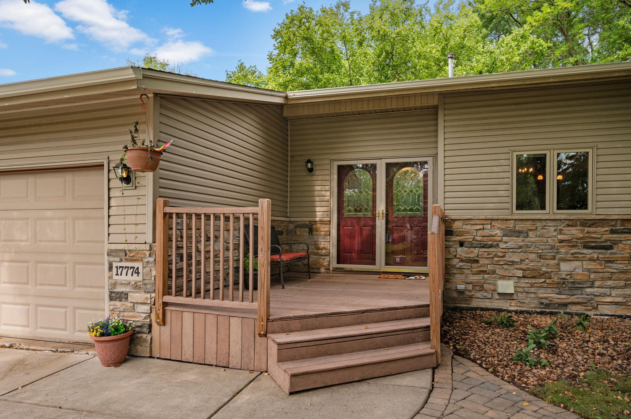 Inviting front entry deck offering a cozy spot for outdoor seating and curb appeal