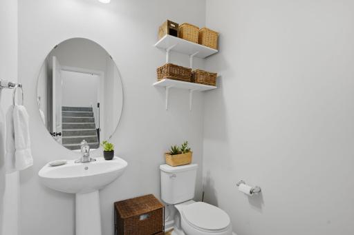 The main level powder room is perfectly positioned for guests and everyday convenience.