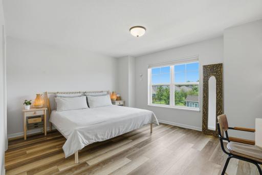 The spacious primary suite is a peaceful retreat designed for rest and relaxation.