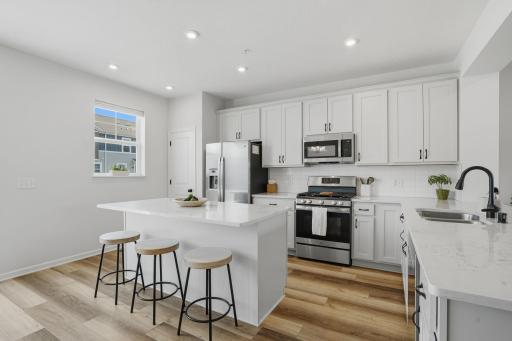 Stainless steel appliances, generous prep space, and thoughtful design make this kitchen as functional as it is beautiful.