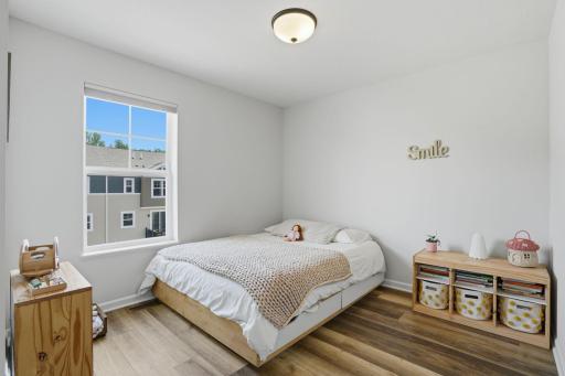 Two additional upper-level bedrooms offer flexible space for family, guests, or working from home.