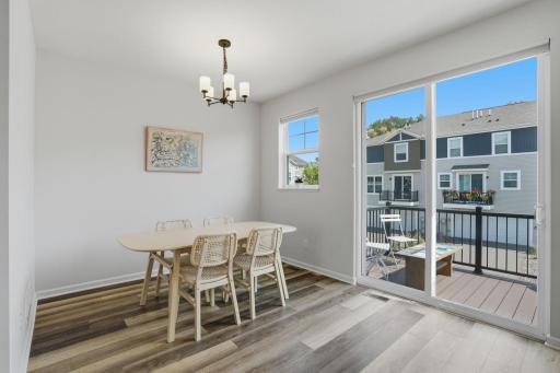 The dining area opens directly to the private deck, making indoor-outdoor entertaining effortless.