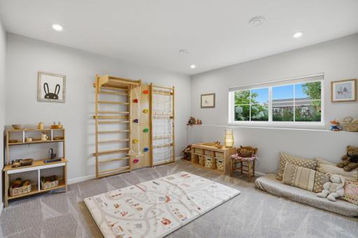 A versatile lower-level flex room offers endless possibilities for a home office, gym, family room, playroom, or creative studio.