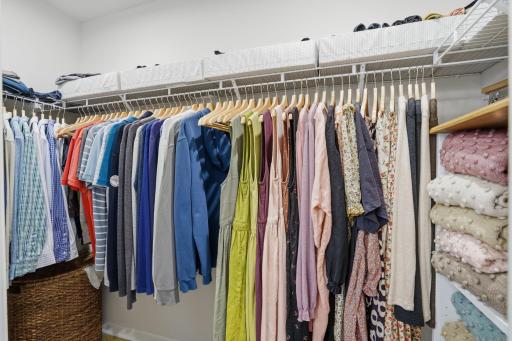 An oversized walk-in closet provides exceptional storage and organization.