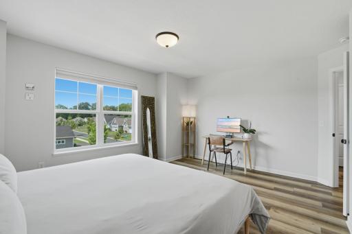 Wake up to serene neighborhood views from the comfort of your private primary bedroom.