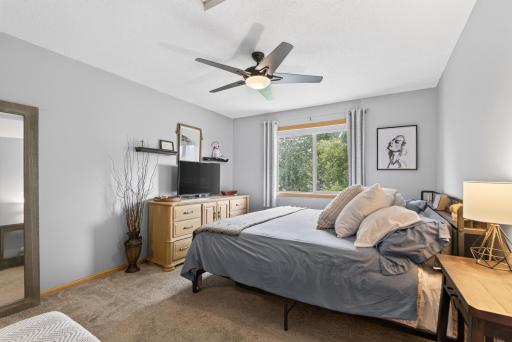 Upstairs primary bedroom with walk in closet and a view of the backyard!