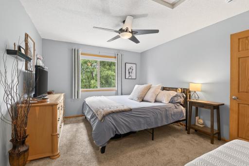 Upstairs primary bedroom with walk in closet and a view of the backyard!