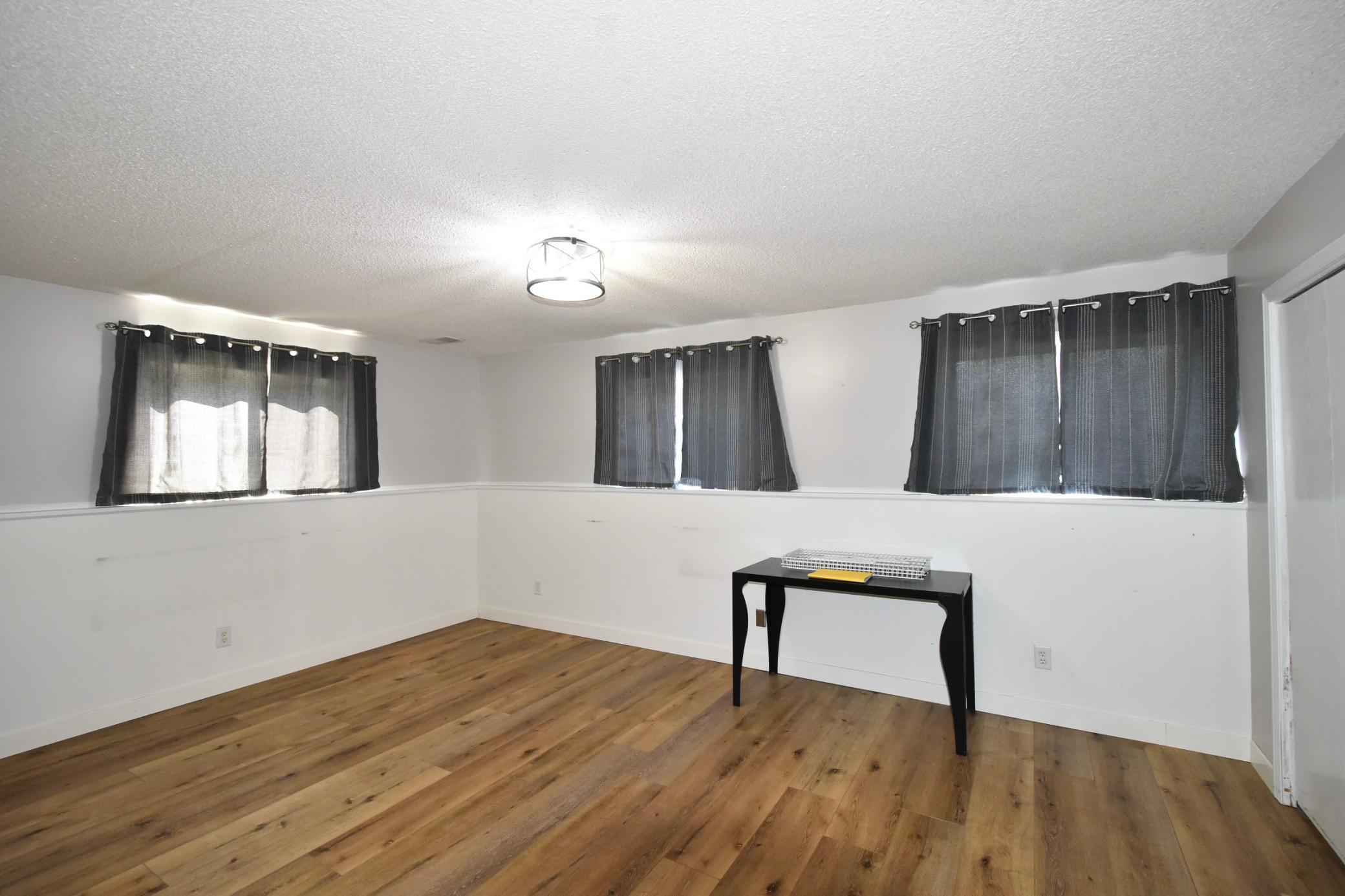 basement family room with luxury vinyl planking
