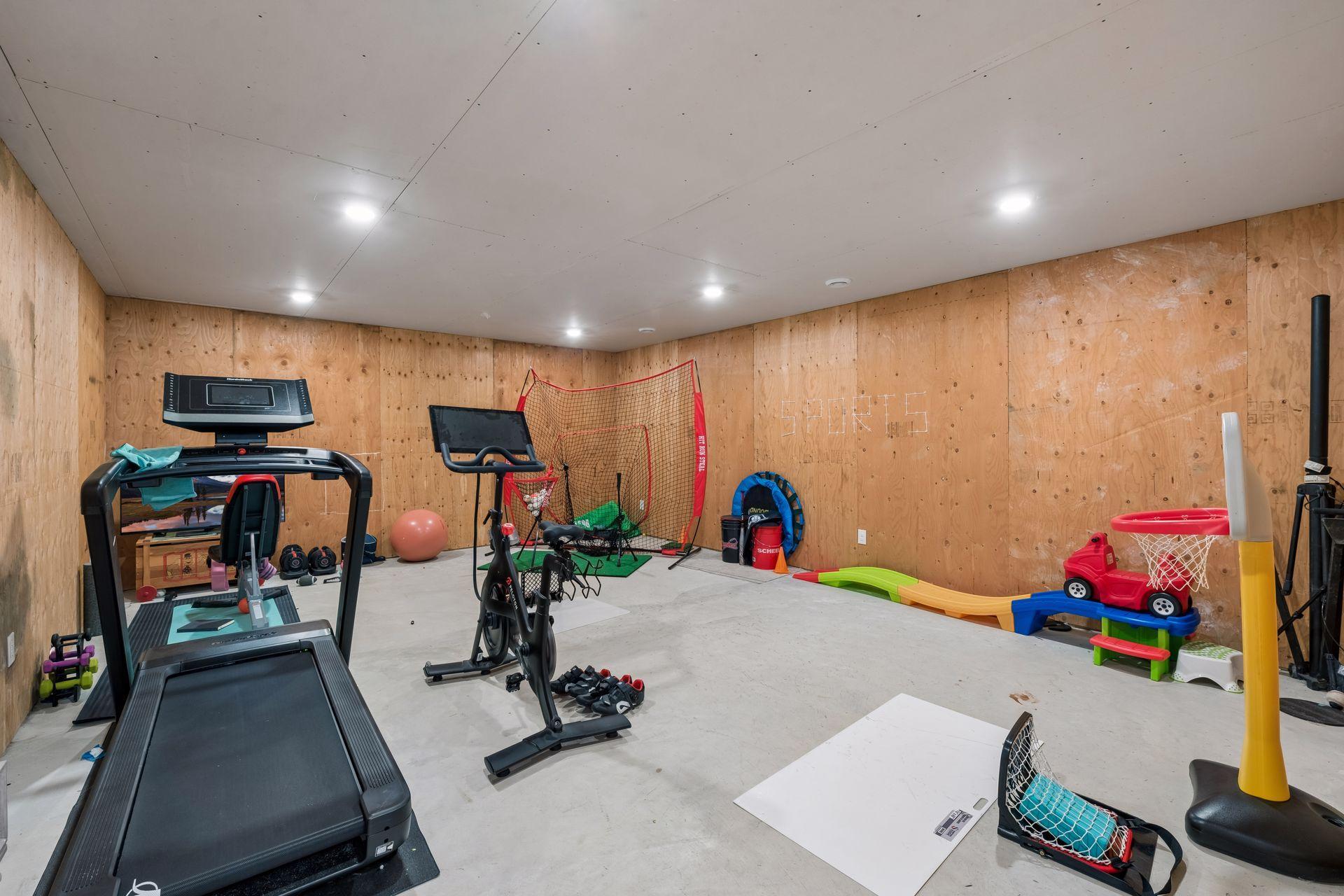 Lower-level flex room, currently serves as an exercise and sports room