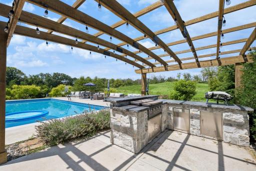 Outdoor kitchen, complete with a gas-fed Blackstone grill and pizza oven