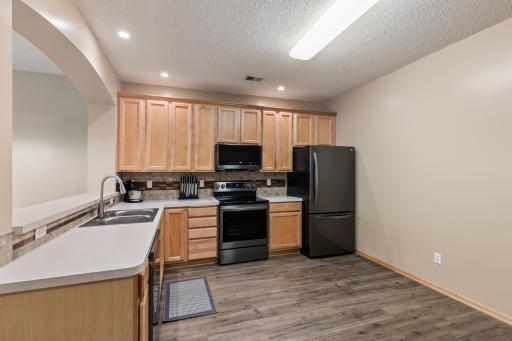 Newer slate black stainless steel appliances beautifully accent the kitchen.