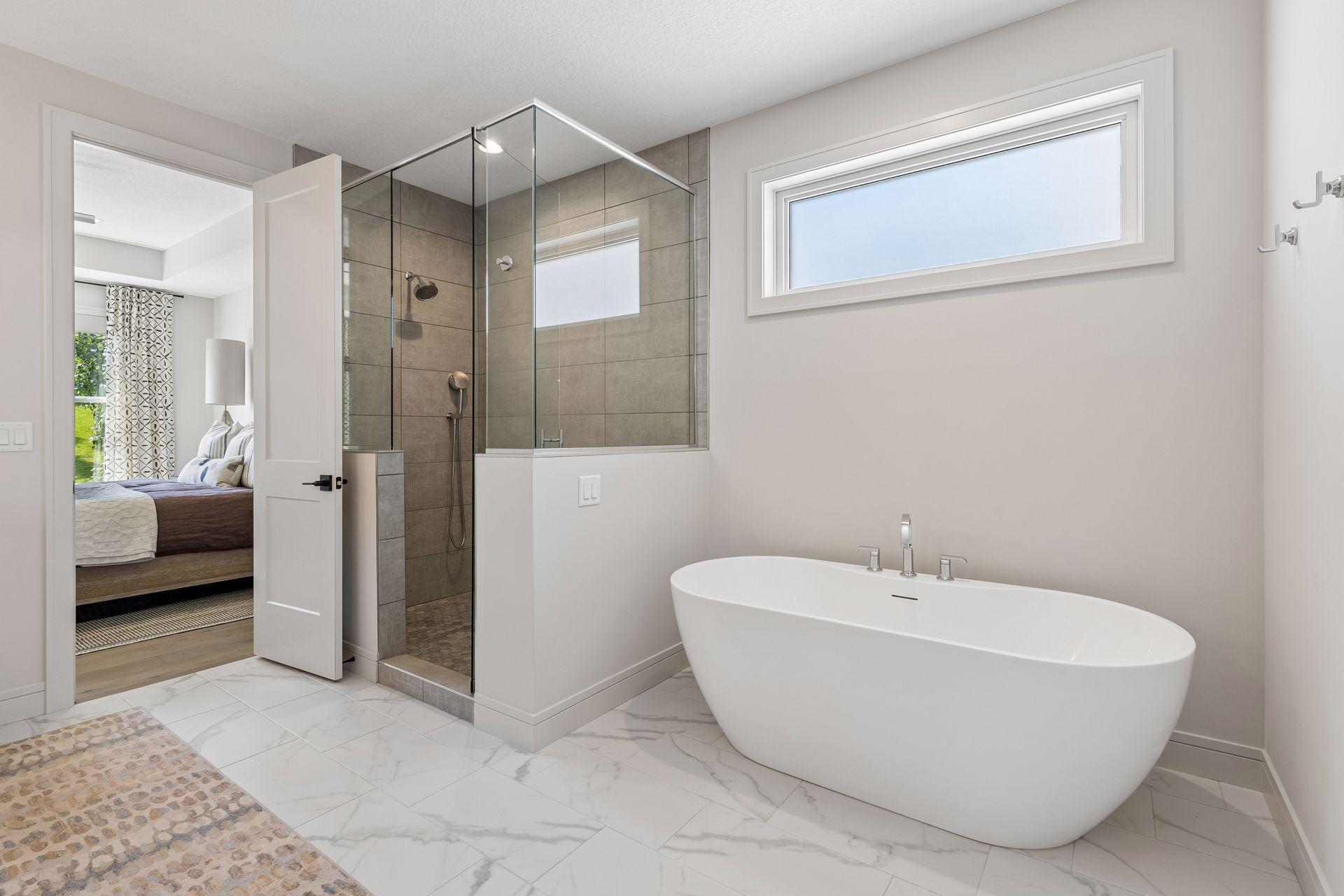 The private, owner's bath offers both a floor-to-ceiling tiled shower, and free standing soaking tub.