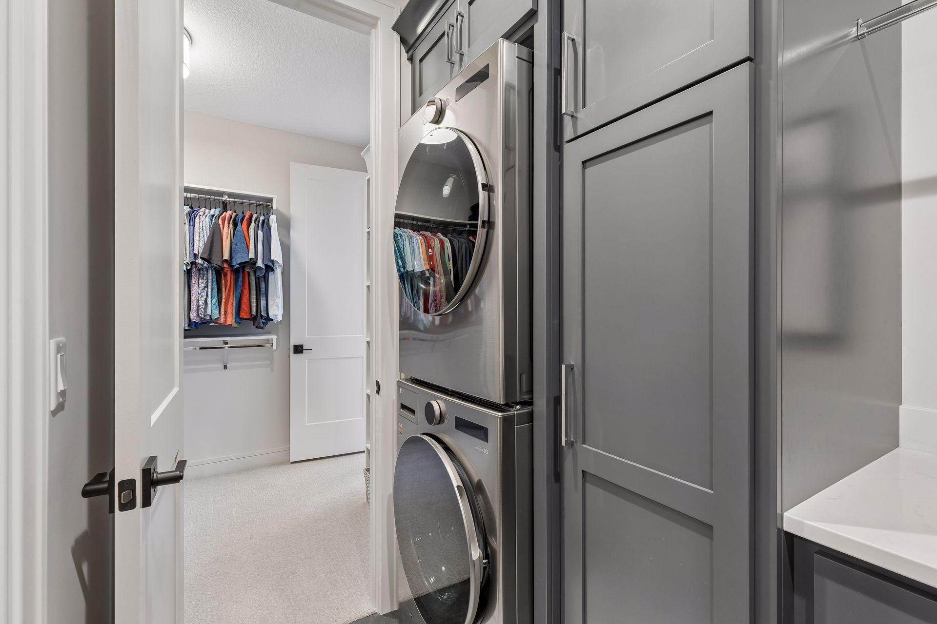 Laundry room with custom cabinetry and access off the owner's closet.