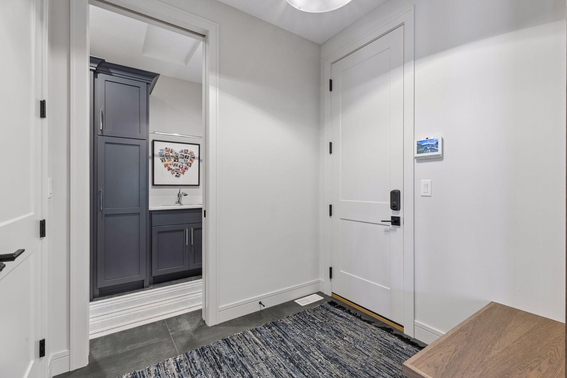 Mudroom with coat closet, drop desk, and direct access to the laundry room.