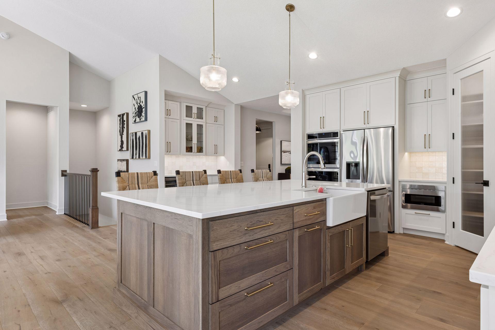 In addition to the ample storage the kitchen has to offer, there is also a buffet area with glass cabinets and beverage fridge.