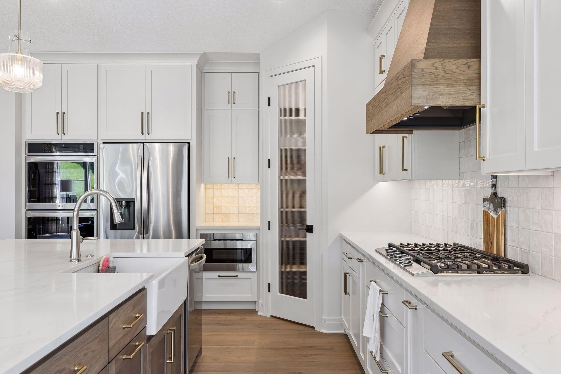 Walk-in pantry with melamine shelving and LG appliances.