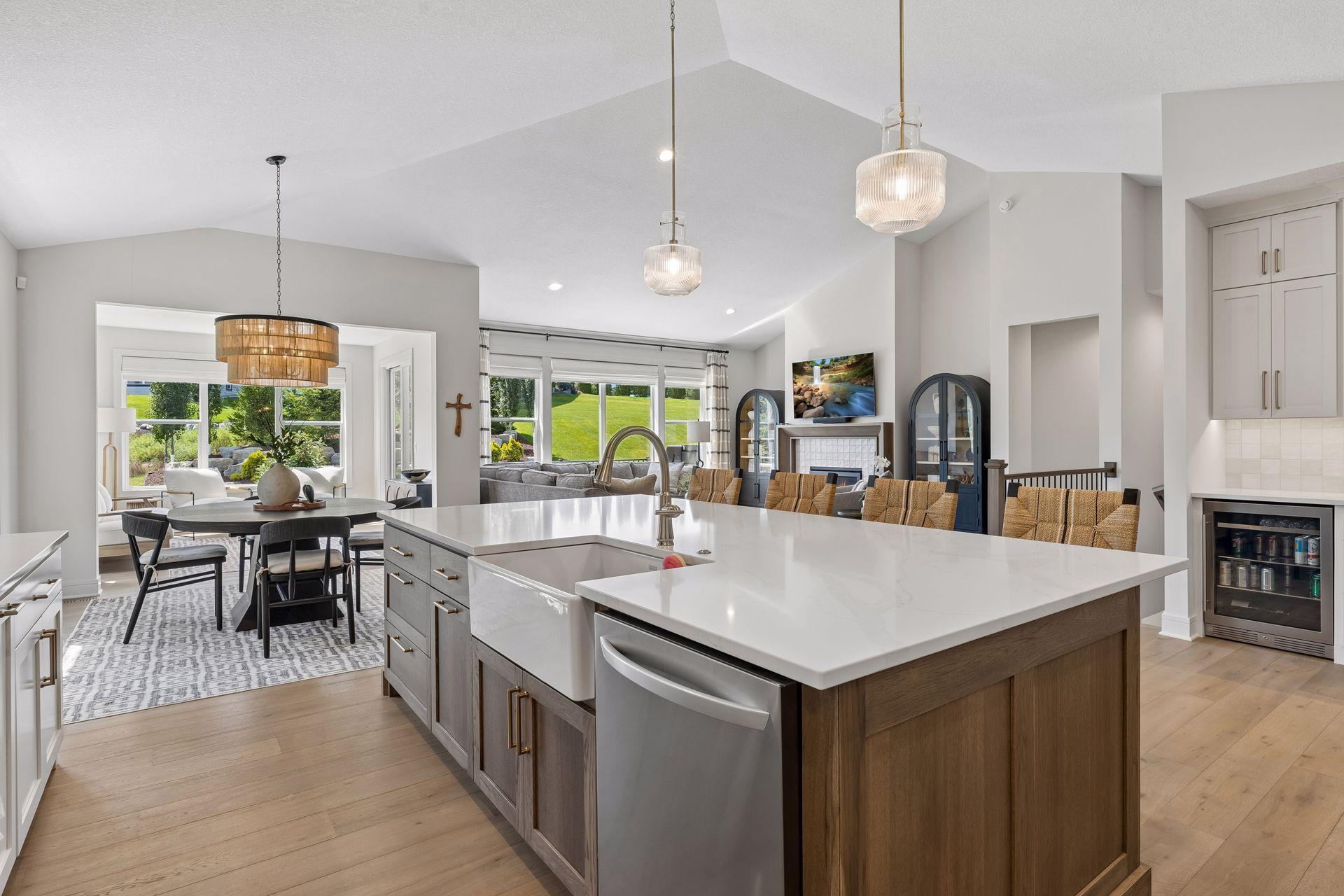Large center island with single bowl farmhouse sink and quartz countertops.