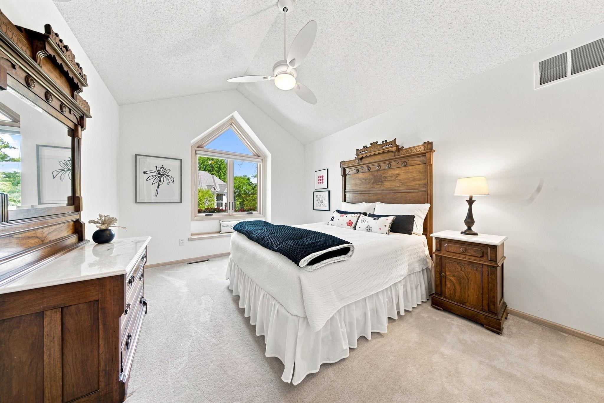Bedroom 2 with a vaulted ceiling and a custom closet