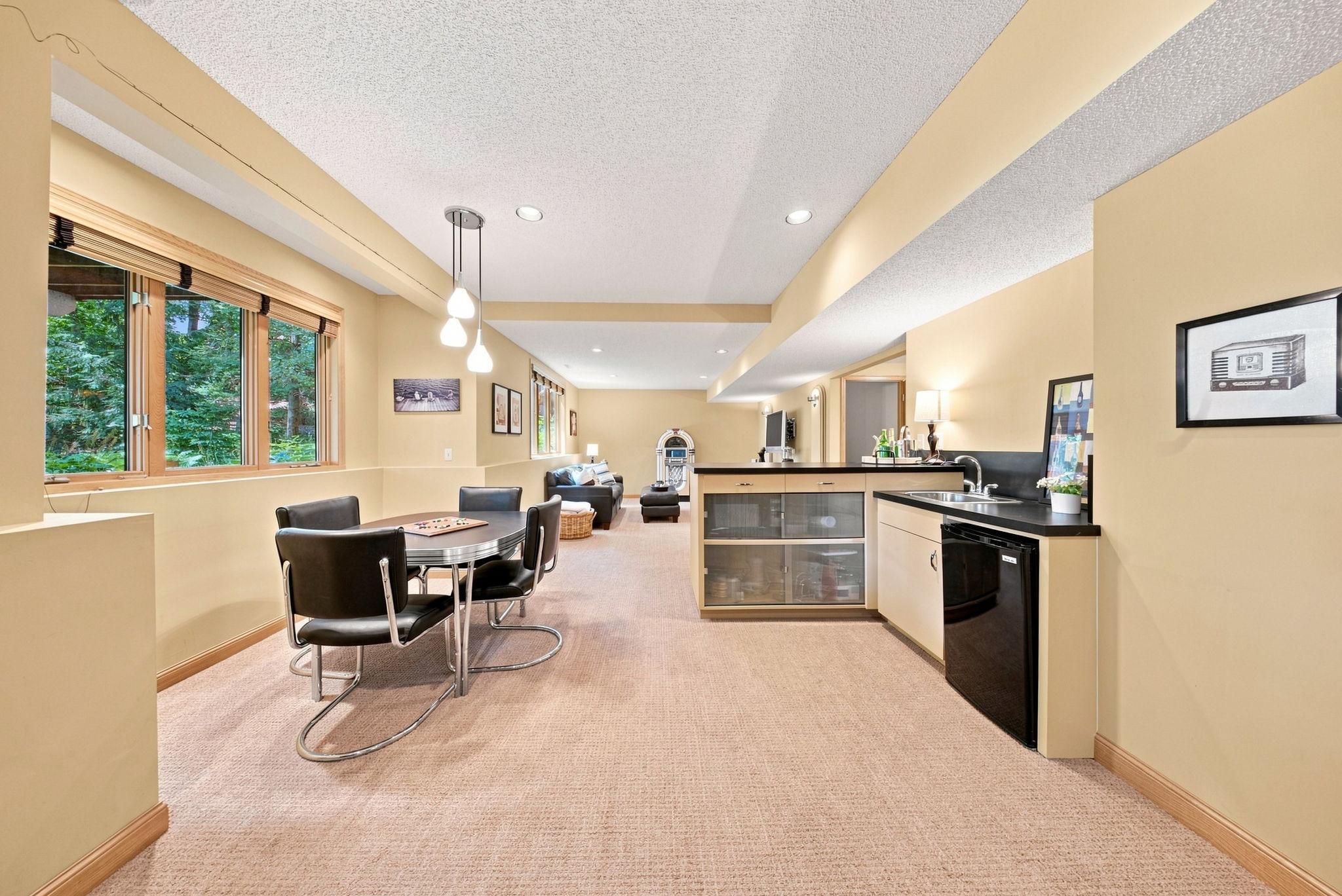 The wet bar is perfectly situated in the lower level