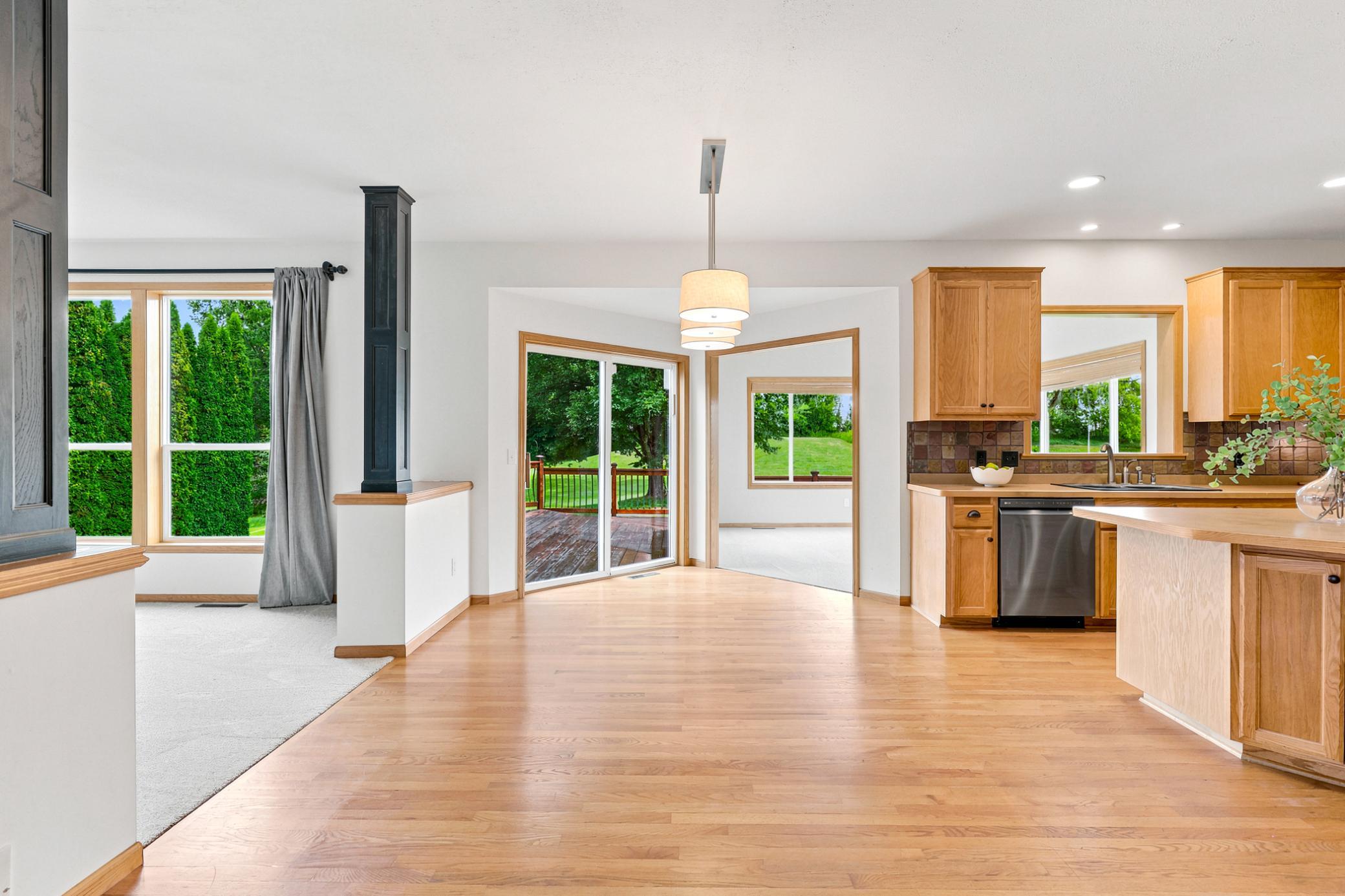 The spacious informal dining area is filled with natural light and opens directly to the deck, offering the perfect setting for everyday meals and effortless indoor-outdoor entertaining.