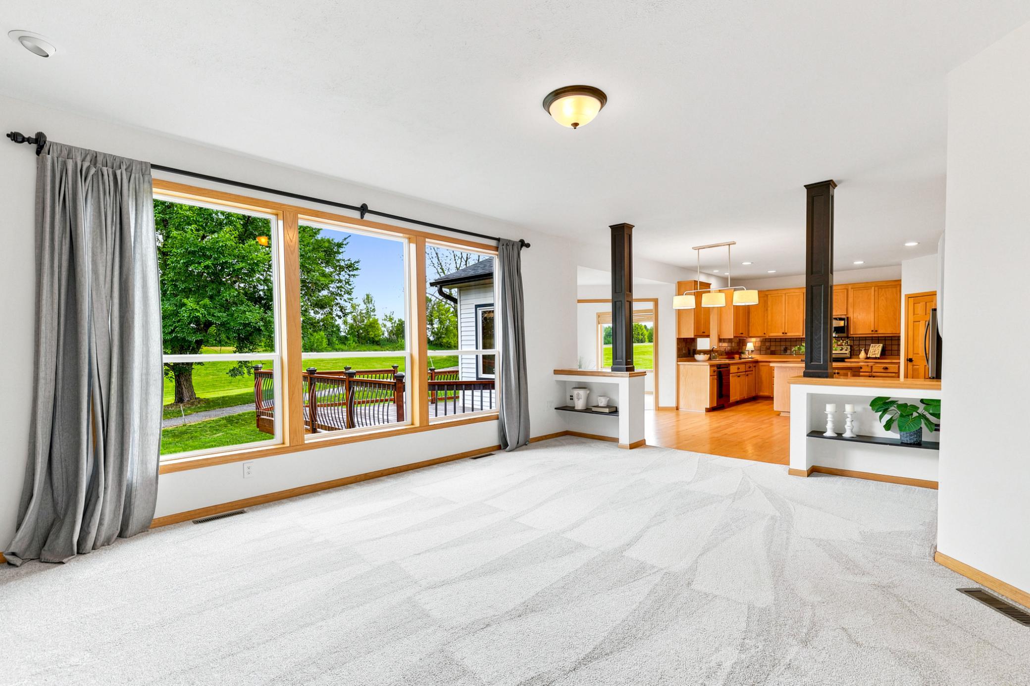 Expansive windows frame picturesque views of the Boulder Pointe Golf Course, filling the great room with natural light and creating a bright, relaxing atmosphere year-round.