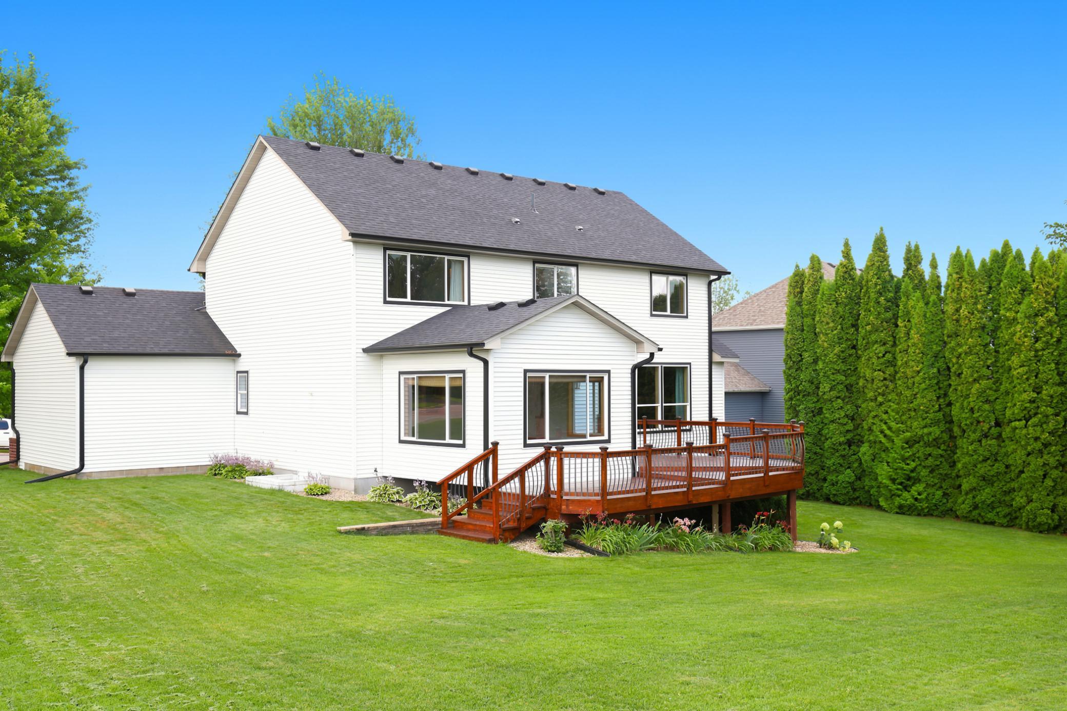 Enjoy the perfect blend of privacy and scenery from the expansive deck overlooking the Boulder Pointe Golf Course, surrounded by mature landscaping and a beautifully manicured backyard.