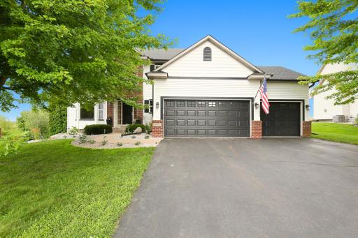 Welcome home! A graceful curved walkway, professionally landscaped grounds, and an inviting covered front porch create exceptional curb appeal and a warm first impression.