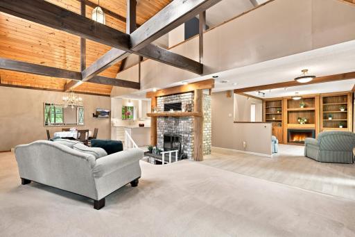 Wood burning fireplace, vaulted ceiling, and gas fireplace (flame AI)