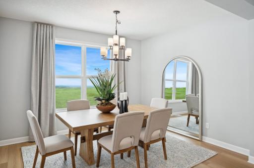 (Photo of a decorated model, actual homes finishes will vary) Have a meal in this formal dining room.
