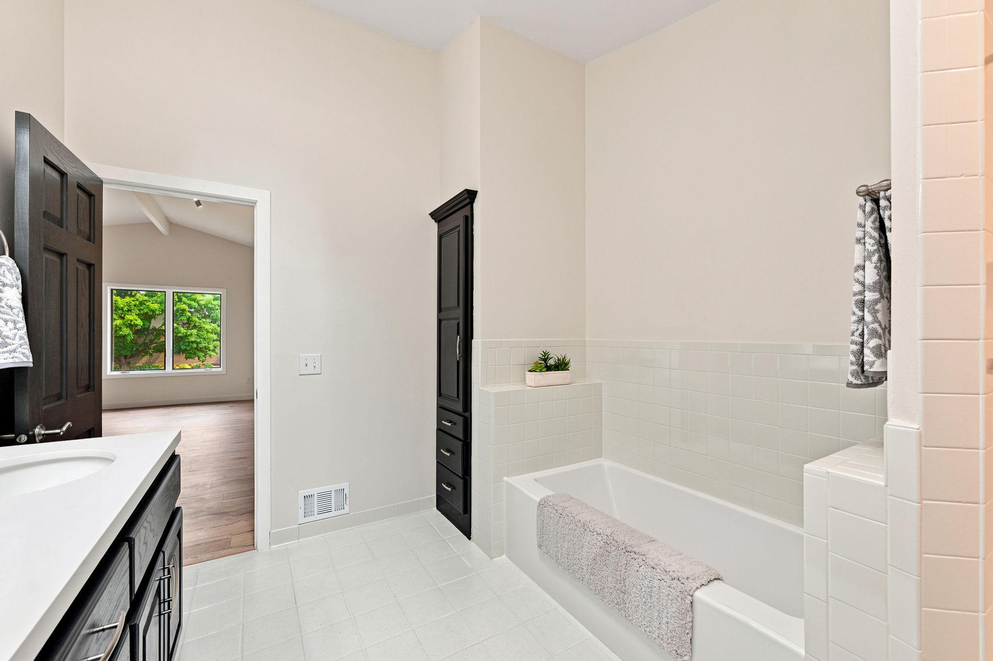 The primary bath has plenty of storage space including a separate linen closet!