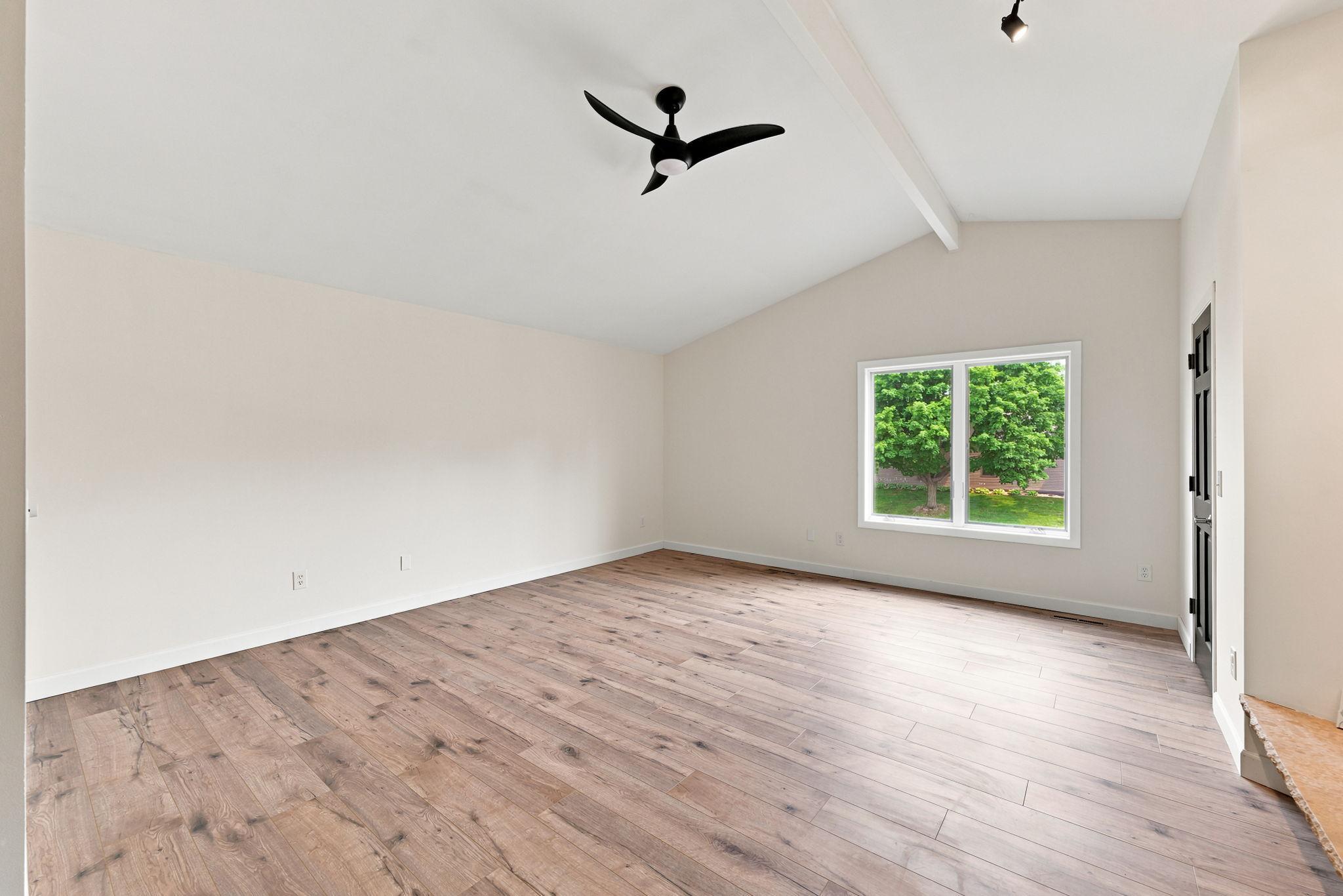 The vaulted, 16 x 18 primary bedroom has more than enough space for a large king bed and furniture!