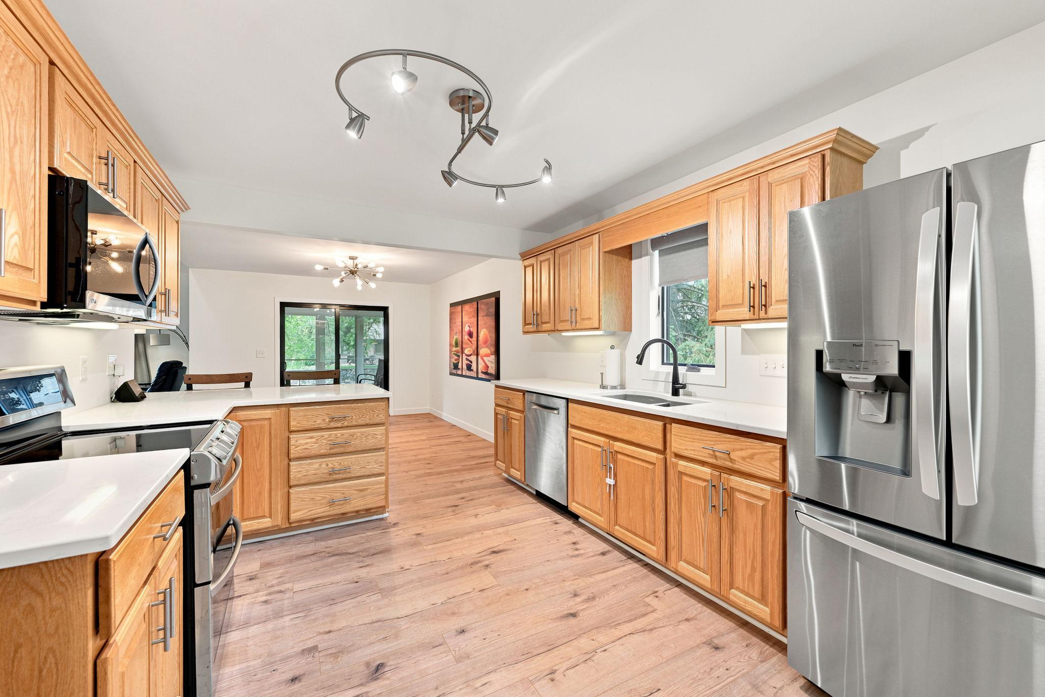 The large, perfectly appointed kitchen includes newer stainless steel appliances, and a window over the sink!