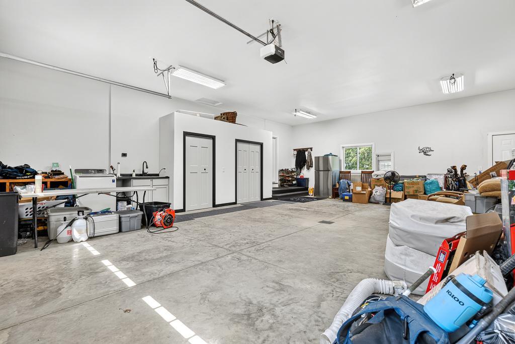 The attached, finished garage features some new built-in storage closets and sink!