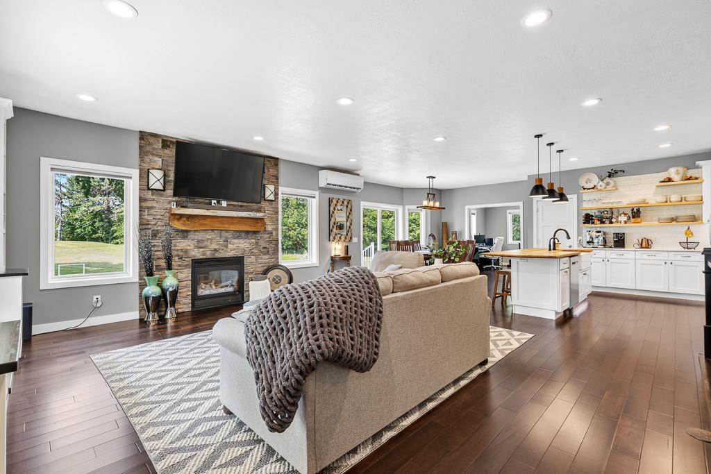 Step inside an inviting open concept main living area - The dark wooden flooring contrasts beautifully amongst the fresh paint throughout the home.