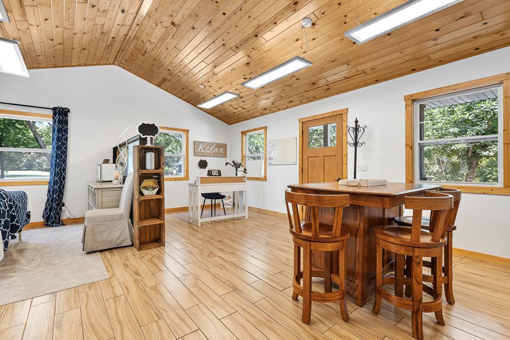 Interior of the office space shows beautiful vaulted ceilings, bright and natural lighting, stunning wood ceilings and floors!