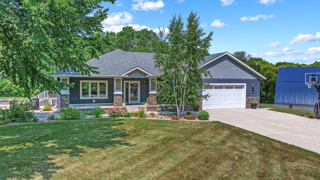 Striking curb appeal sets the tone from the meticulous and colorful landscaping, to the pillar and stone accents