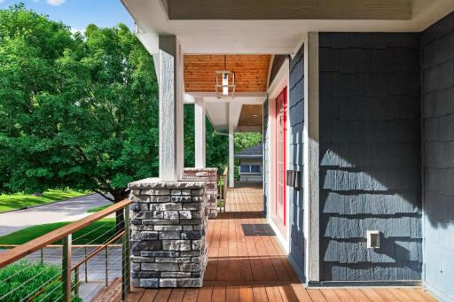 A welcoming front porch framed by beautiful stonework.