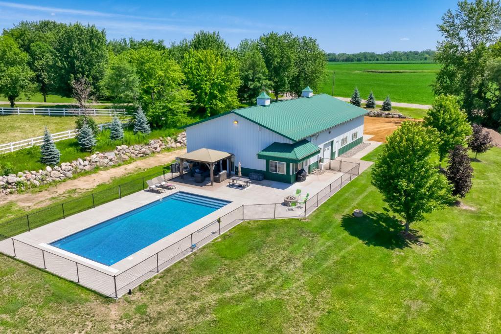 9815 Pioneer Trail - 42' x 80' Pole Shed with 1200+ sq ft of living space AND a Saltwater Pool!