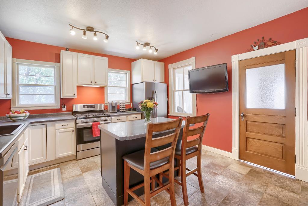 9815 Pioneer Trail - Update Kitchen with white cabinets, stainless steel appliances, kitchen windows and a fantastic center island!
