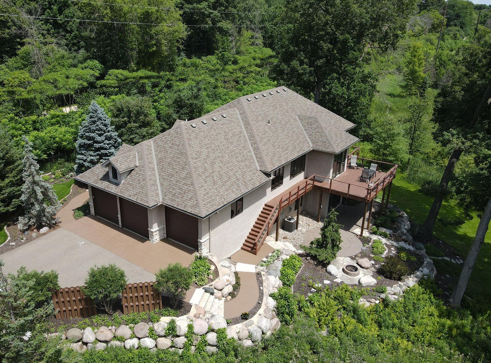 The aerial view highlights the significant investment in professionally designed landscaping, creating a stunning outdoor oasis. Thoughtfully designed gathering spaces, lush plantings that create inviting setting for entertaining or quiet relaxation