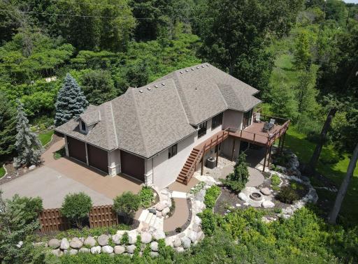 The aerial view highlights the significant investment in professionally designed landscaping, creating a stunning outdoor oasis. Thoughtfully designed gathering spaces, lush plantings that create inviting setting for entertaining or quiet relaxation