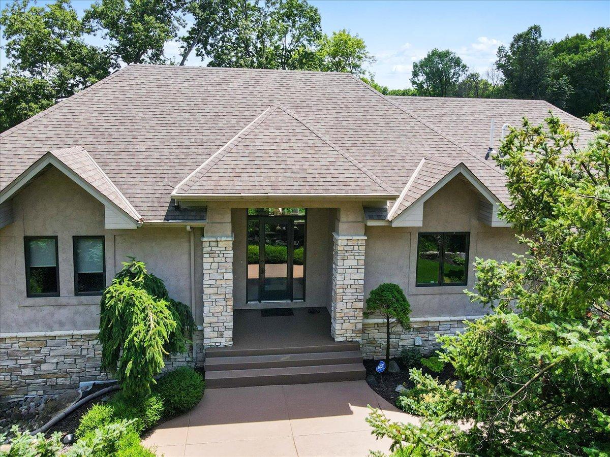 Welcome to 4294 Windwood Way. The moment you arrive, striking curb appeal sets it apart. Beautifully crafted rooflines, a timeless blend of stucco and stone create a distinguished architectural presence and makes a lasting first impression.