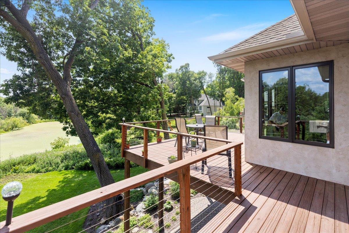 Designed to maximize outdoor living, the expansive wraparound deck extends from the garage across the entire rear of the home and the owner's suite, creating an extraordinary setting for entertaining or simply enjoying the surrounding nature.
