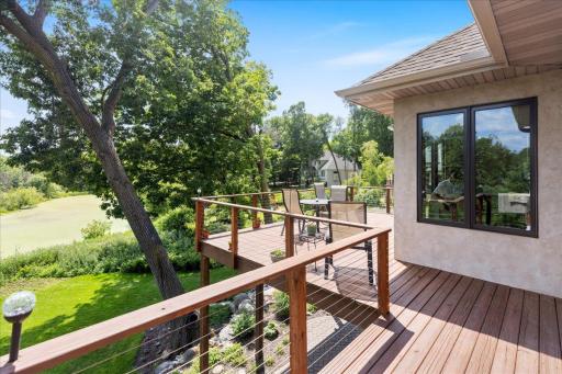 Designed to maximize outdoor living, the expansive wraparound deck extends from the garage across the entire rear of the home and the owner's suite, creating an extraordinary setting for entertaining or simply enjoying the surrounding nature.