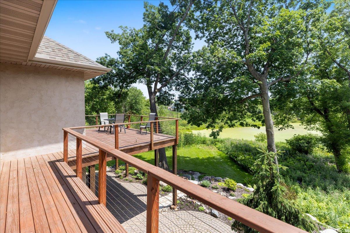 Take in the expansive views overlooking the surrounding woods and wetlands. The private backyard setting offers a peaceful natural backdrop, creating a rare sense of seclusion while still providing beautiful year-round scenery.