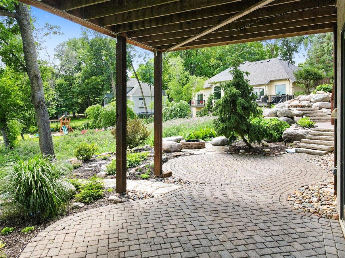 The extensive landscaping with expansive paver patios and impressive boulder retaining walls and beautifully crafted terraced garden beds. The result is a private, park-like setting designed for both relaxation and entertaining.
