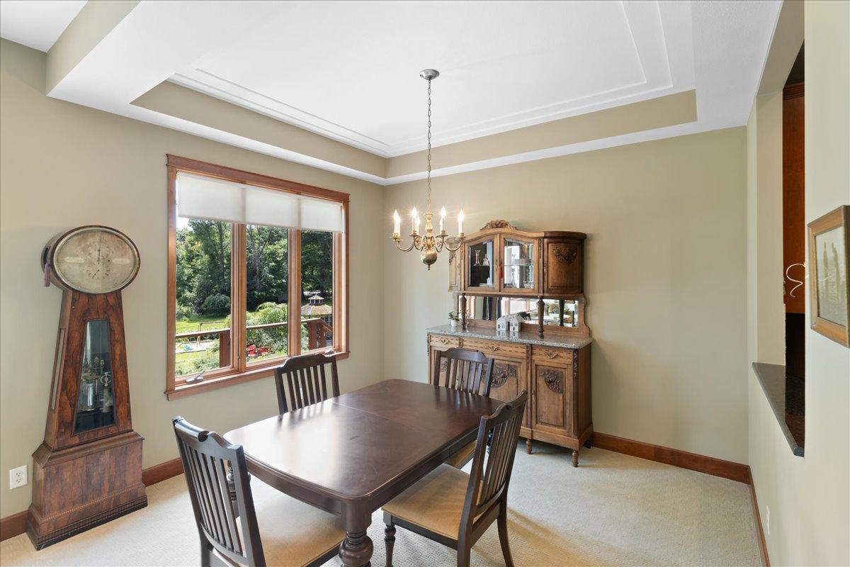 The formal dining area is thoughtfully defined by a graceful racetrack ceiling detail, adding architectural character and sophistication. Generously sized to accommodate large gatherings, memorable meals and elegant entertaining or daily dining.